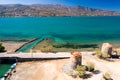 Old windmills and canal on a narrow causeway and site of an ancient Minoan city Elounda, Crete, Greece Royalty Free Stock Photo