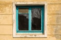 Old window in an abandoned house with blue wooden frame Royalty Free Stock Photo
