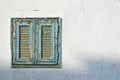 The old window with blue shutters on a white wall Royalty Free Stock Photo