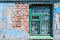 Old window with a broken brick wall