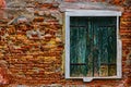 an old window in a broken brick wall Royalty Free Stock Photo