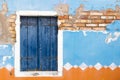 The old window with closed blue wooden shutter. Horizontally. Royalty Free Stock Photo