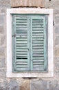 Old window with closed shutters on an old house