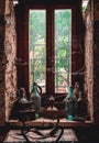 Old window covered with a spiderweb, vintage glass bottles, jugs, and iron on the windowsill Royalty Free Stock Photo