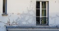 Old window with cracking plaster in Paris