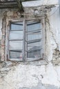 old window with curtain on dilapidated house facade Royalty Free Stock Photo