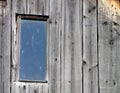 Old window on the damaged wooden roof