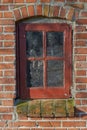 Old, window and exterior with brick wall of rustic wooden frame, abandoned house or building. Glass of historic outdoor Royalty Free Stock Photo