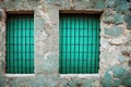 Old window frame with steel bars shutter exterior as prison or residential apartment front view. Weathered house wall Royalty Free Stock Photo
