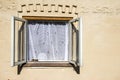 Old window frame with white old style curtain Royalty Free Stock Photo