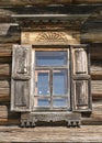 Old window with glass with a blue sky on the background of the wooden wall of the countryside log house Royalty Free Stock Photo