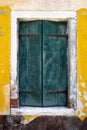 Old window with green shutter on yellow wall. Italy, Venice, Royalty Free Stock Photo