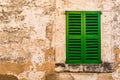 Old window with green shutters and grunge vintage wall Royalty Free Stock Photo