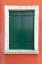 Old window with green shutters on red wall Royalty Free Stock Photo