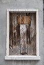 Old window hammered wooden planks on a stone wall, an abandoned farmhouse Provence.