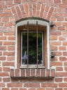 Old window with iron bars in a brick stone wall Royalty Free Stock Photo