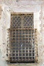 Old window with iron grating Royalty Free Stock Photo