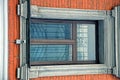 An old window with a lattice on a brick wall of an apartment house Royalty Free Stock Photo