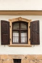 Old window made of stone and wood with brown shutters Royalty Free Stock Photo