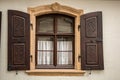 Old window made of stone and wood with brown shutters Royalty Free Stock Photo