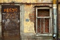 Old window with metal scribed door and drain pipe on an old peel Royalty Free Stock Photo