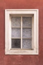 Old window onred stucco wall Royalty Free Stock Photo