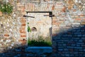 Old window open onto courtyard of old abandoned and ruined building. Facade of a house built with stones and bricks. Royalty Free Stock Photo