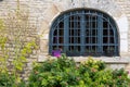 Old window of an old public building decorated with multiple flowers Royalty Free Stock Photo