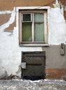 Old window and scratched painted wall of old town Riga house, Latvia