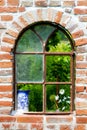 Old window in the stone wall in the garden Royalty Free Stock Photo