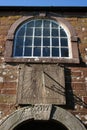 Old window, sundial, dated keystone, old church