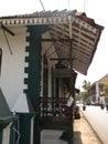 old window with terra-cotta tiled roof. An architectural details from Goa, India. Royalty Free Stock Photo