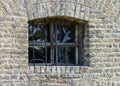 Old window to renovate with bars on a yellow brick wall Royalty Free Stock Photo