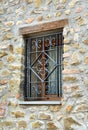 Window with iron grating on stone wall Royalty Free Stock Photo
