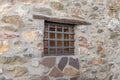 Old wooden window and iron grating on stone wall Royalty Free Stock Photo