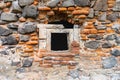 Old window in a wall made of volcanic stone ad bricks Royalty Free Stock Photo