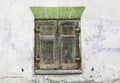 Old window with weathered closed shutters.