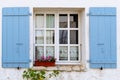 Old window with wooden blue painted shutters Royalty Free Stock Photo
