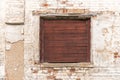 Old window with wooden shatter on wall of abandoned building Royalty Free Stock Photo