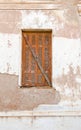 Old window with wooden shutters on a damaged wall, closeup background Royalty Free Stock Photo