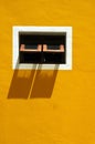 An Old Window on a Yellow Wall Royalty Free Stock Photo