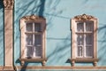 Old windows with carved architraves Royalty Free Stock Photo