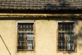 Old windows, house facade and sunlight Royalty Free Stock Photo