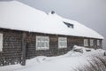 Old windows of a old mountain hut and gray wooden wall covered with snow Royalty Free Stock Photo