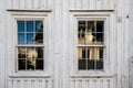 Old windows in a Norwegian house with white wood planks. Very old house wall. texture Royalty Free Stock Photo