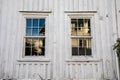 Old windows in a Norwegian house with white wood planks. Very old house wall. texture Royalty Free Stock Photo