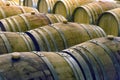 Old wine barrels in rows inside a wine cellar