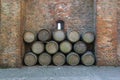 Old wine barrels stacked against a rustic brick wall
