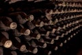 Old wine bottles aging in vintage wine cellar