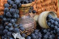 Old wine pitcher and clay glass, winemaking emblem and a cork.